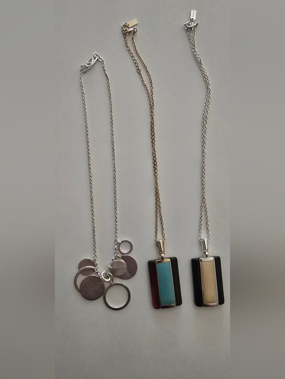 3 Necklaces. 1 Black Cream Pendant 1 Turquoise And Brown Pendant, 1 Silver(26